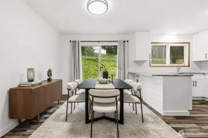 Staged kitchen dining area with sliding glass door to rear yard.