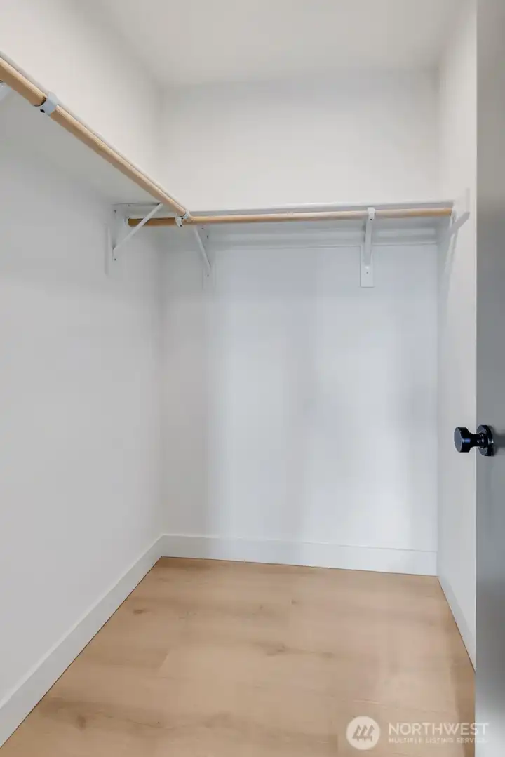 Top floor primary suite with a spacious walk-in closet.