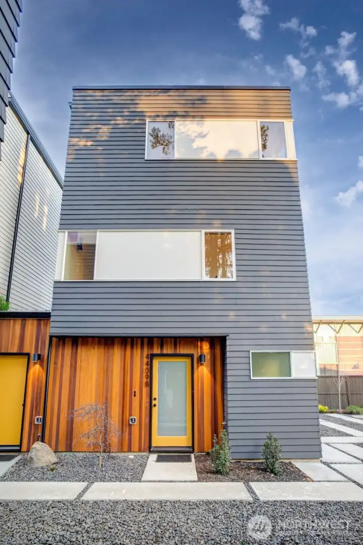 4409B is a three-level home with the primary suite on the top floor, the middle level hosts the open living & kitchen area, and the entry level has a large foyer with a coat closet, and a spacious guest suite with an adjacent full-tiled bathroom. Modern clean lines, abundant natural light, and mindful design.