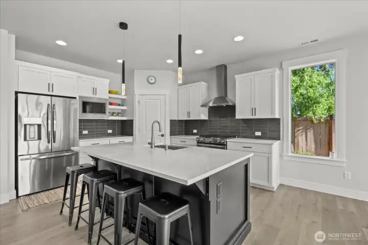 Quartz countertops and high end appliances and touchless faucet.