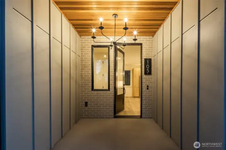 Covered front entry with sleek modern finishes.