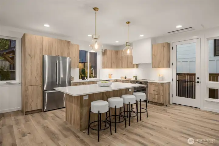 A kitchen designed to gather — generous island, custom cabinetry, and quartz counters.