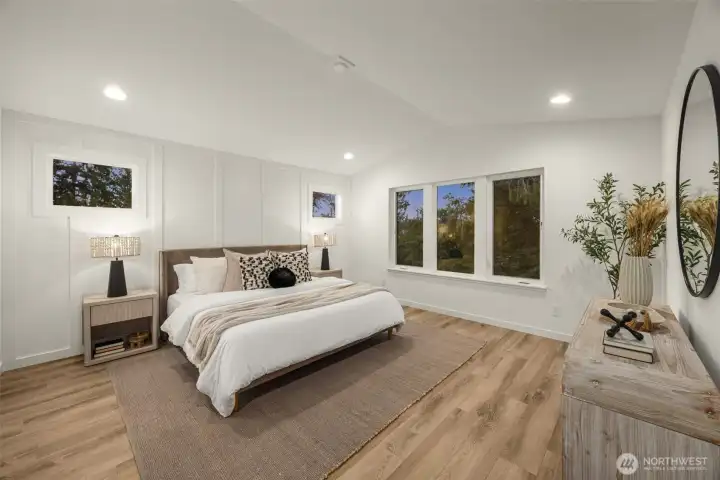 A calm, comfortable primary suite retreat with designer finishes and oversized windows.
