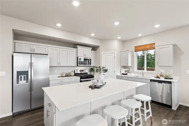This oversized island has ample storage and is great for baking and or food prep! Photos are for representational purposes only.  Colors and finishes may vary. Refrigerator is a builder option.