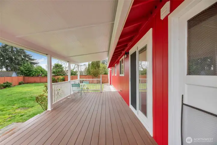 Oversized covered upgraded Trex deck off kitchen slider overlooking the large leveled yard