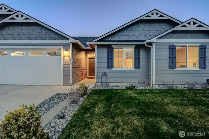 This quality home boasts craftsman-style architecture with shutters, oversized windows, and contrasted hardi-plank siding.
