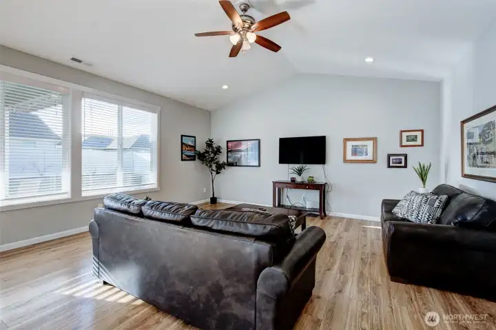 The vaulted ceiling, large windows and warm plank floors invite you to sit and stay a while...