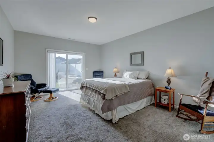 Spacious primary bedroom provides space for even the largest furniture, and enjoys direct access to the patio!