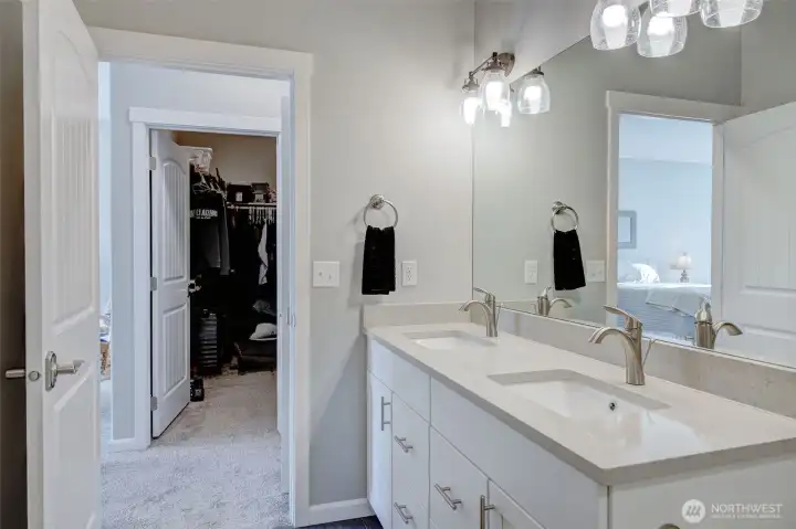 Primary bath sits right across the hall from the oversized walk-in closet.