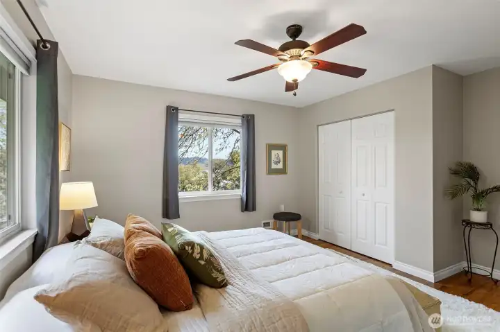 Another view of the primary bedroom with views of the lake.