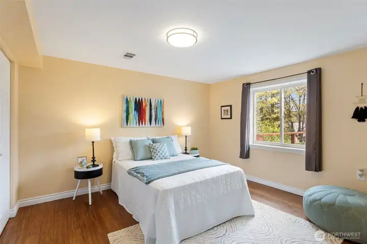 A serene space to relax in, this 2nd lower level bedroom faces east to enjoy the beautiful sunrises!