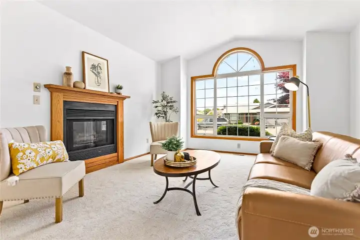 Spacious living room with a large picture window and a gas fireplace