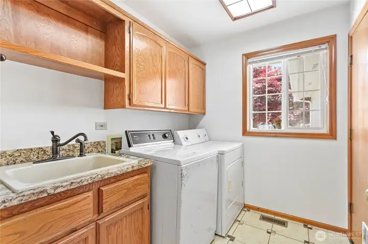 Spacious laundry/mudroom with garage access.