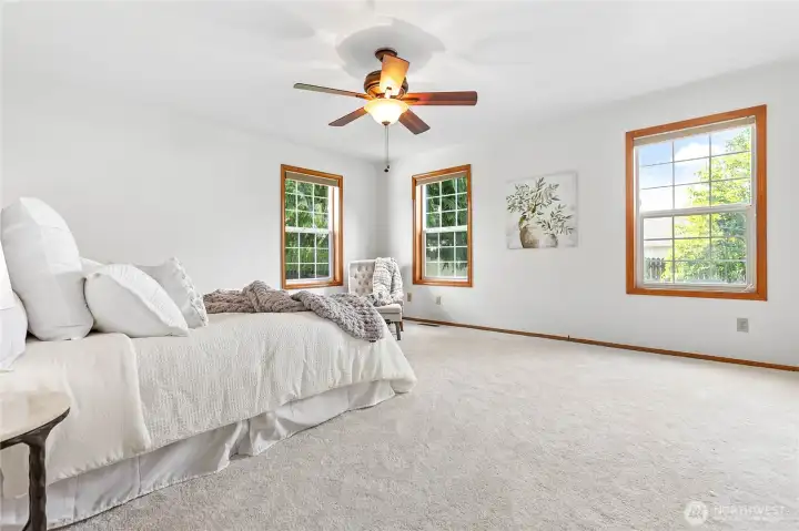 Light and bright, spacious primary bedroom with new carpet