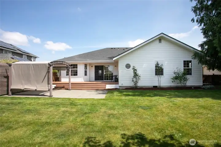 The pergola, deck, and backyard space are perfect for entertaining and summer BBQs.