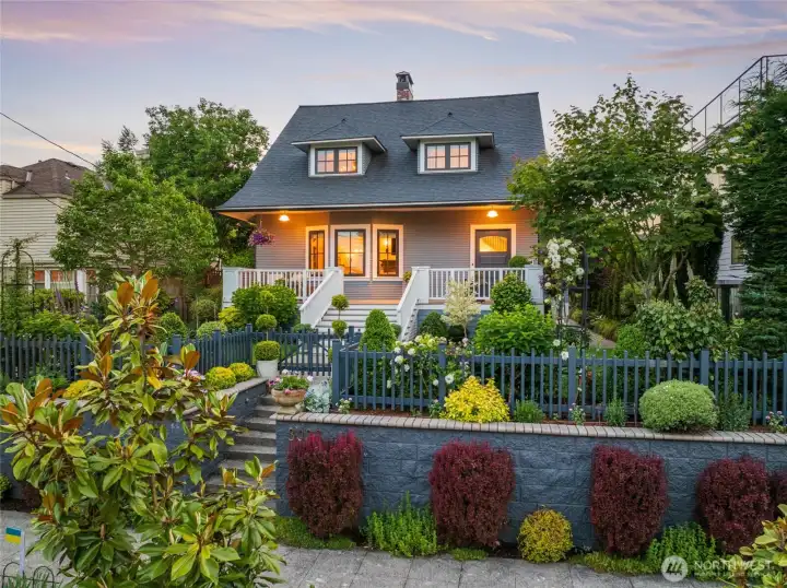 Blending elevated farmhouse warmth with classic Craftsman architecture, the home offers beautifully scaled living spaces filled with natural light, custom millwork, designer Visual Comfort lighting, built-in casework and cabinetry, and refined yet livable elegance with generous storage. Premium details abound, including solid brass and bronze hardware, Armac Martin cabinet hardware, and Rohl plumbing fixtures throughout. The stunning chef’s kitchen features an expansive walnut island, Wolf appliances, Sub-Zero refrigerator, soapstone counters, and a beautiful Shaw’s farmhouse sink, anchoring the home and flowing seamlessly into the dining room. The sophisticated main floor offers elegant yet comfortable living spaces, including a beautifully appointed living room and stylish powder room accented with designer wallpaper, oak hardwoods, and another Shaw’s sink.
