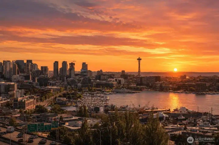 Watch the city come alive at sunset as vibrant colors reflect across Lake Union and the Seattle skyline from this remarkable vantage point.