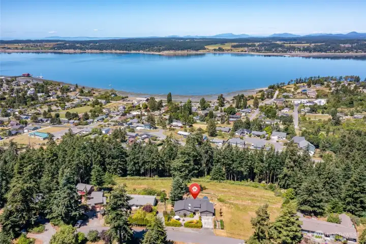 Situated in a quiet neighborhood, near to beaches, walking trails, boat launch and so much more! The historic downtown of Coupeville with the wharf is seen in the upper left corner.