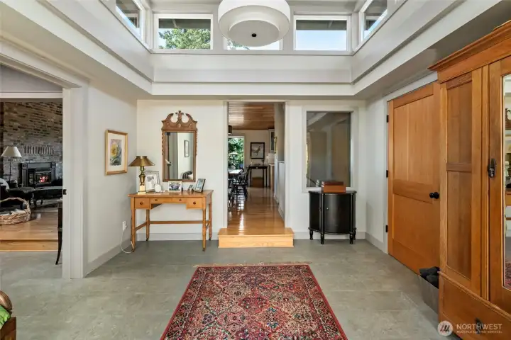 Beautiful foyer, with clerestory windows, expanding natural light. Solid wood doors and heated tile flooring.