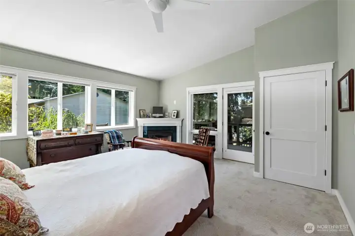 primary bedroom, glass door to deck, propane fireplace