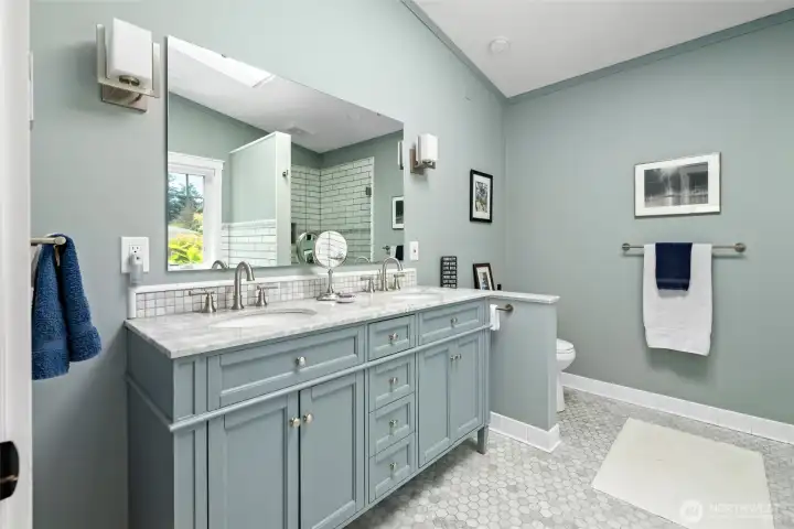 five piece primary en-suite, with skylight, in-floor heating and granite countertop