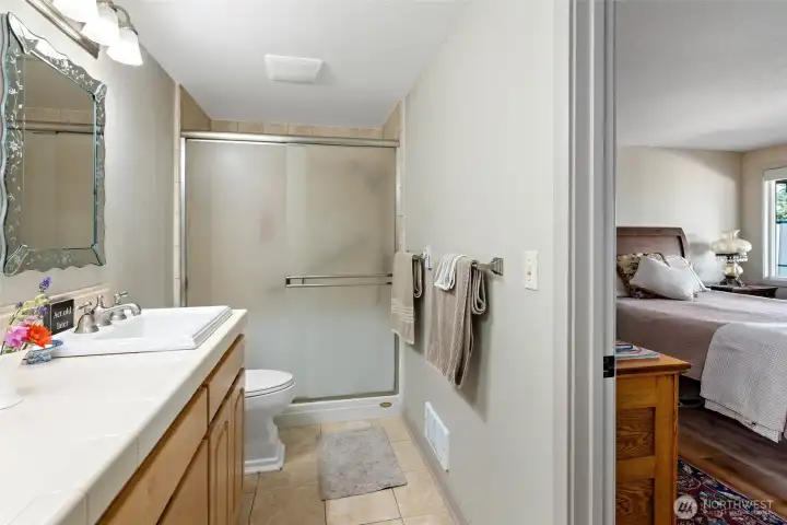 extra large walk-in shower with tile floor and surround.