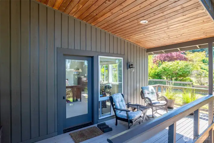 Covered deck outside primary bedroom. Craftsman touches throughout