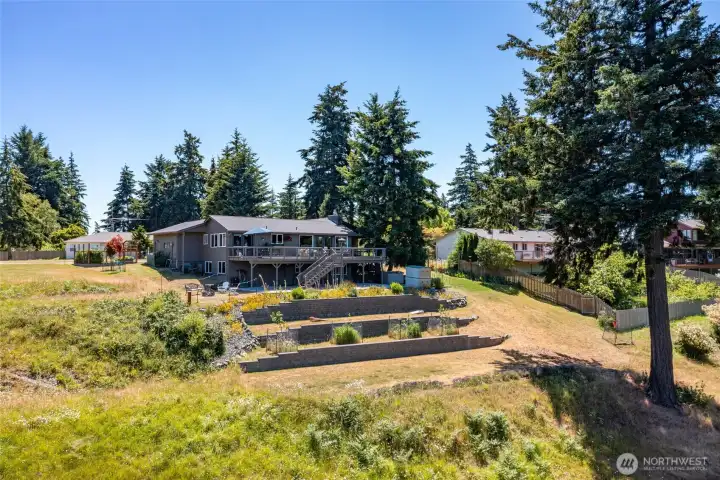 Terraced landscaping on a sun drenched property offers endless possibilities