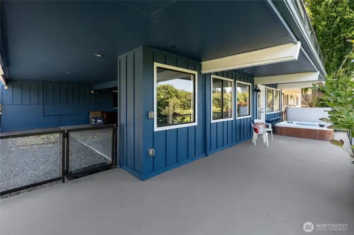 Lower level deck & spa, carport to the left.