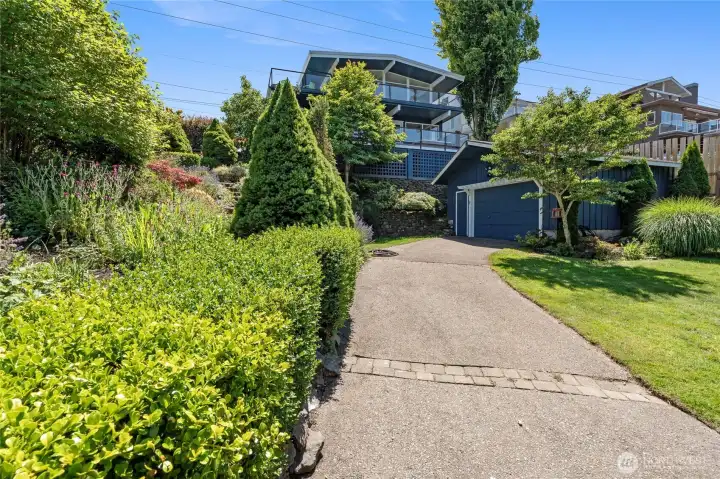 Rear driveway to detached garage and backyard.