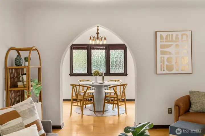 A gothic archway leads into a formal dining room.