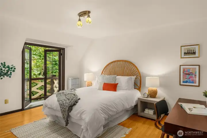 The bedroom facing the courtyard has a walk-in closet and French doors that lead to a romantic birds-eye balcony overlooking the lush garden.