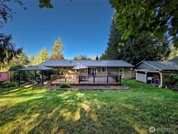 Mostly level, private wooded lot that is fully-fenced with a gate