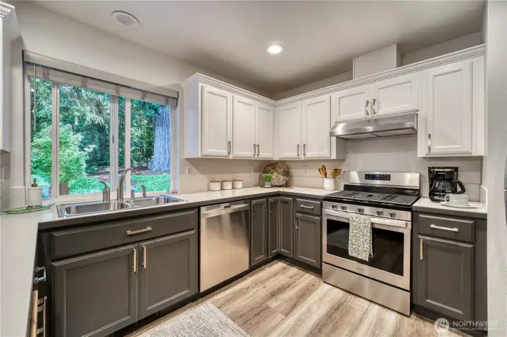 Beautifully remodeled kitchen includes newer stainless appliances, cabinets, and LVP flooring.