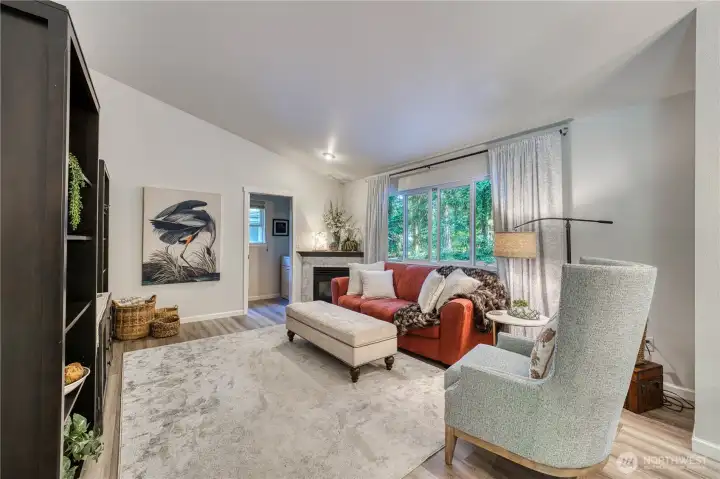 Spacious family room features vaulted ceilings and newer LVP flooring throughout.
