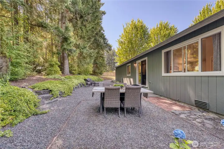 Step outside to paradise and enjoy a low maintenance yard with lush evergreen trees as your backdrop.