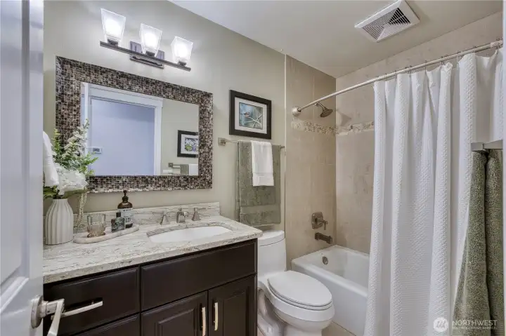 Full and functional hall bathroom with elegant updates.