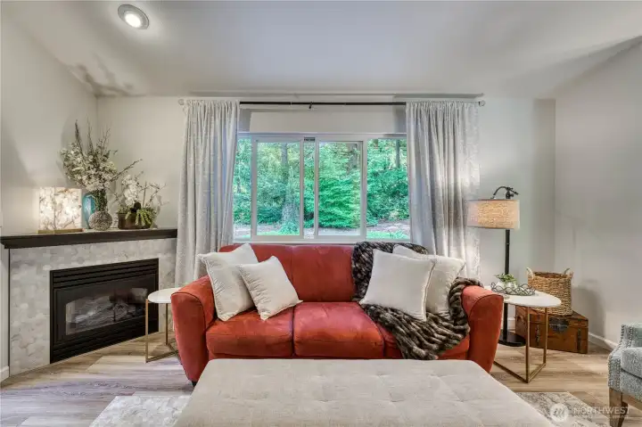 The family room features a cozy gas fireplace and emerald green privacy.