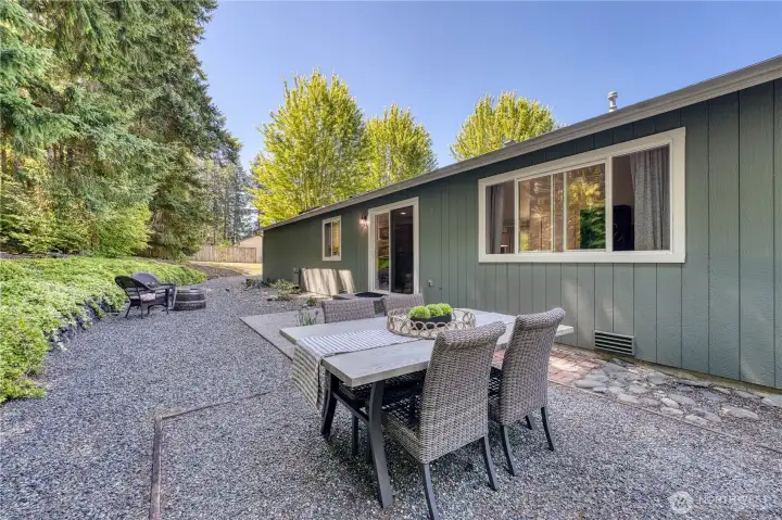Enjoy outdoor dining in this expansive low maintenance yard.
