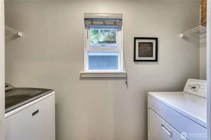 Laundry room is nestled off of the family room.