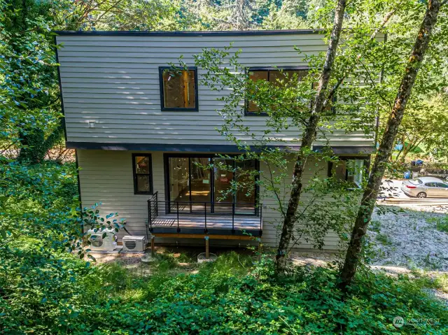 Deck off the dining room leading to the serene backyard