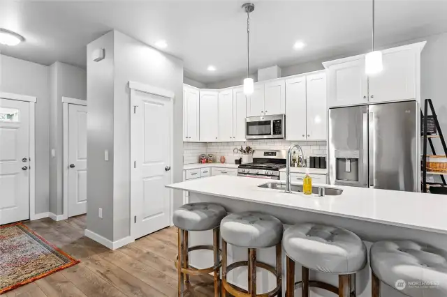 Neutral paint, pantry, and plenty of cabinet space.