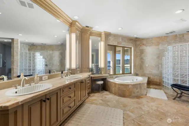 Marble primary bath includes many more cabinets and a coffee station with sink and frig near the entrance. To the right is an enormous Walk in closet done by "California Closets".