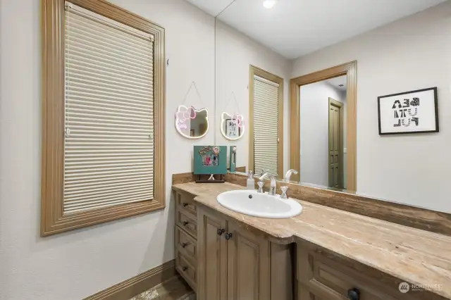 Neutral counters and cabinetry are repeated throughout the bathrooms that pair with the 3 bedrooms.