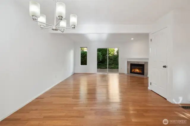 Dining room with view towards living and back deck - shown without staging - look at those floors!