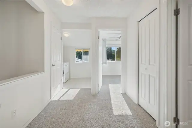 Upper hall with linen closets & pull down ladder to extra storage attic above.
