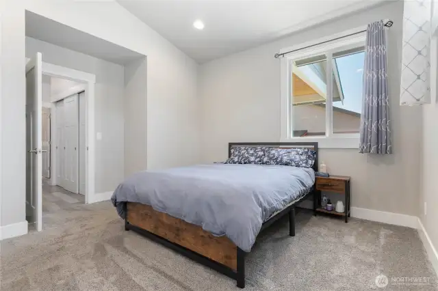 Main floor Primary Bedroom features a vaulted ceiling.