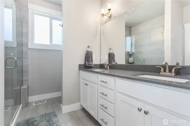 Primary ensuite bathroom with double sinks.