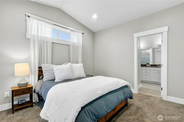 Main floor primary bedroom with en-suite bath and walk-in closet.