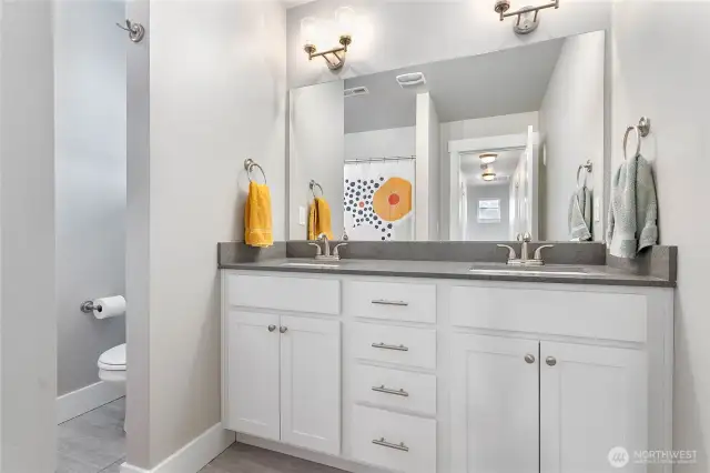 Upstairs full bathroom with double sinks.
